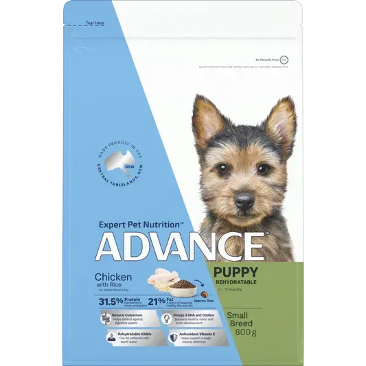 A bag of Advance puppy food featuring a small dog, blue and green packaging with text.