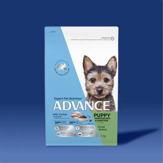 Bag of Advance puppy food with a photo of a puppy on the front, set against a blue background.