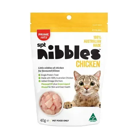 A bag of "spt nibbles" chicken treats for cats; the packaging features a cat and images of chicken.
