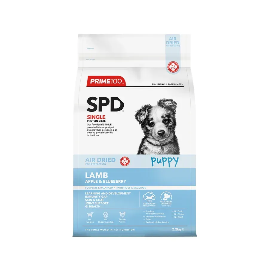 Bag of Prime100 SPD Puppy food, featuring a black and white puppy portrait and blue labeling with product details.