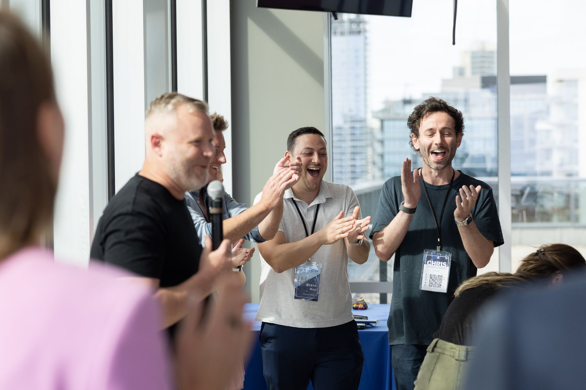 A group of people are clapping their hands in a room.