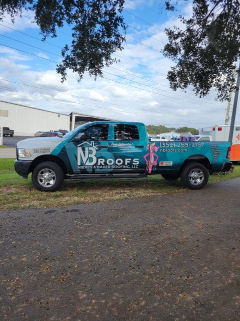 A company service truck is parked on the side of the road next to a tree.