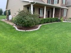 A large house with a lush green lawn in front of it.