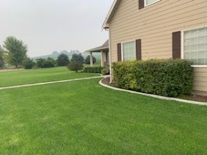 A large house with a lush green lawn in front of it.
