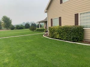 A large house with a lush green lawn in front of it.