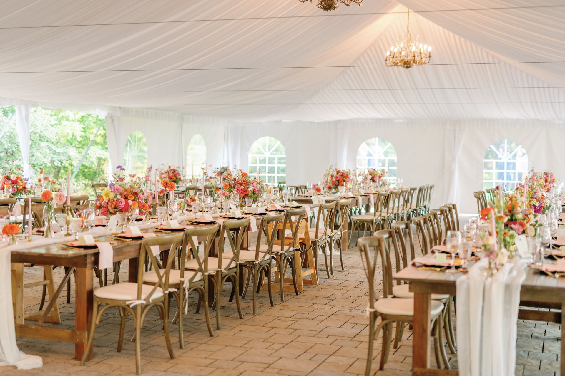 Beautiful wedding reception tent with gorgeous colors of pink all throughout