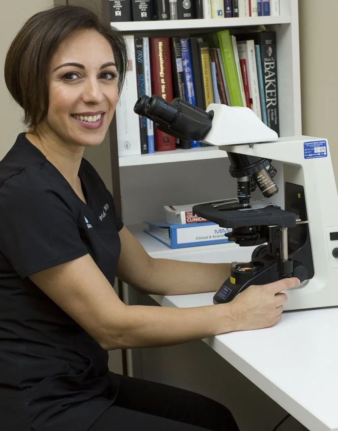 Dr. Sadeghi at microscope