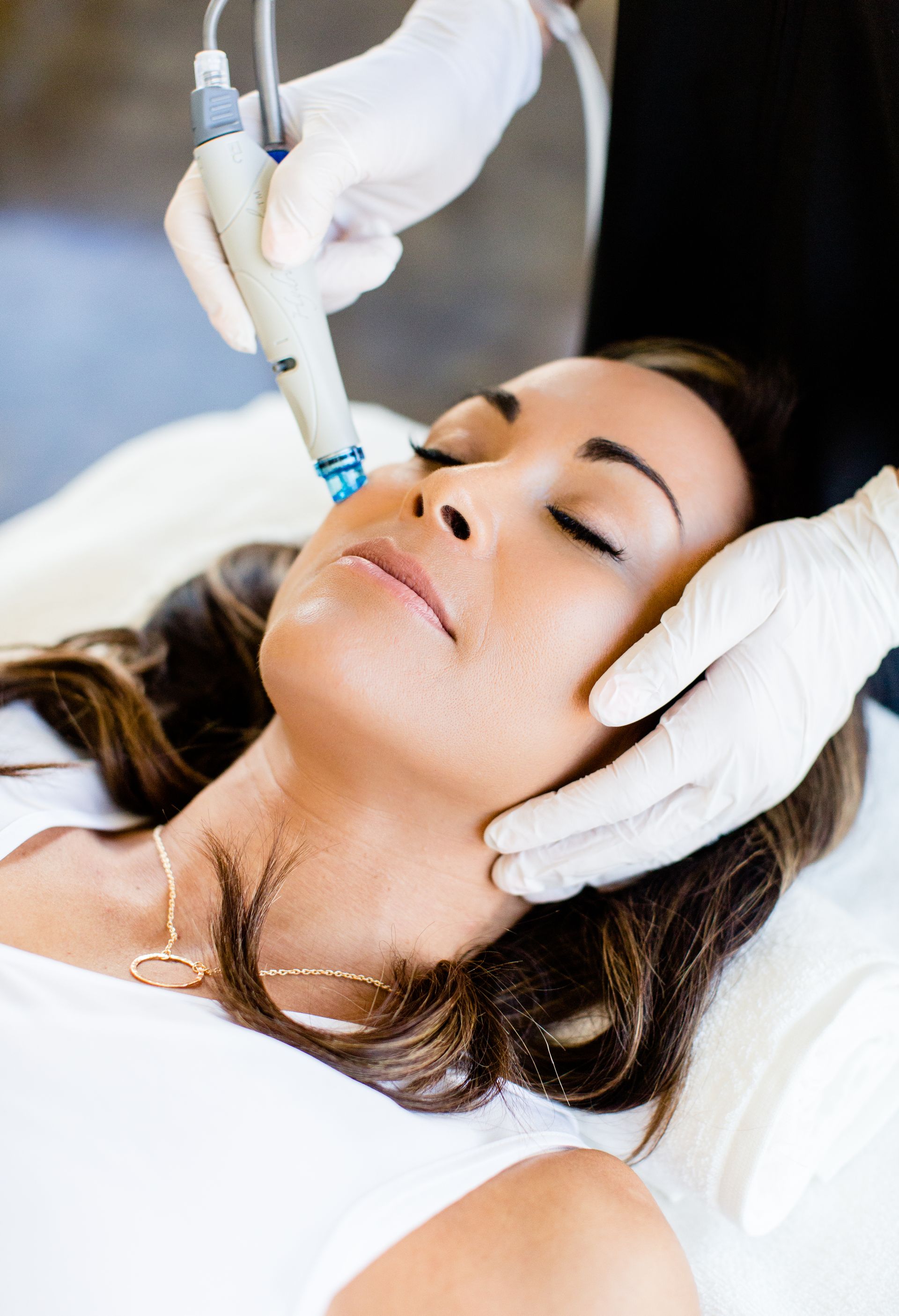 A woman is getting a facial treatment at a beauty salon.