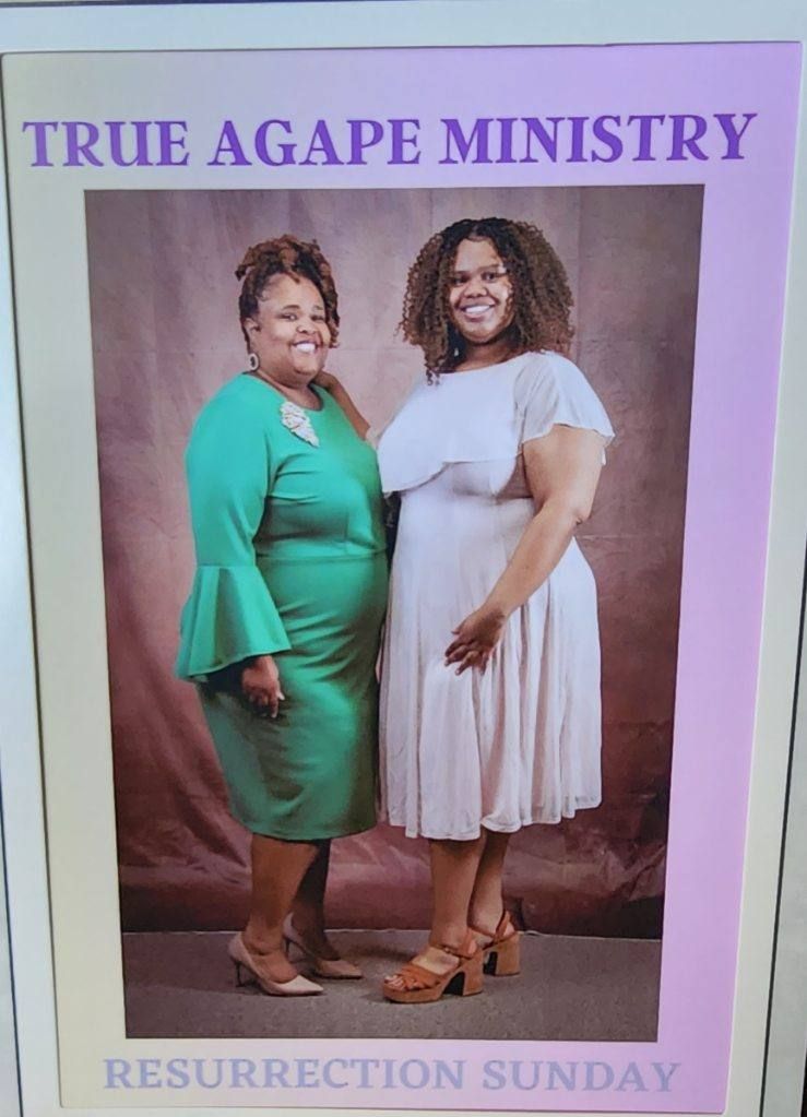 Two women posing for a photo. One in green, the other in white. 