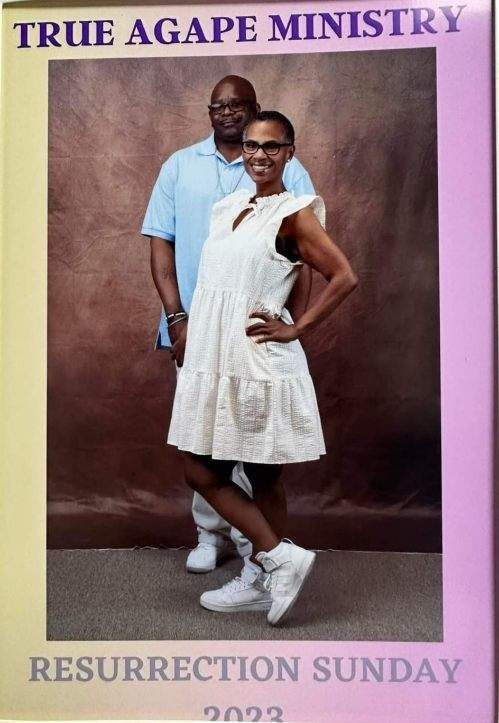 Couple posing in front of a brown backdrop for Resurrection Sunday 2023.
