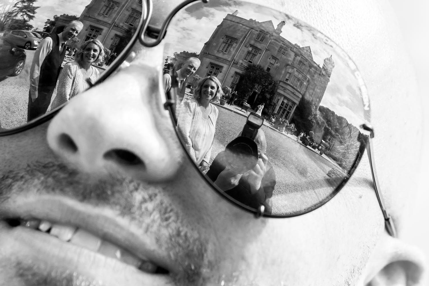 A black and white photo of a man wearing sunglasses