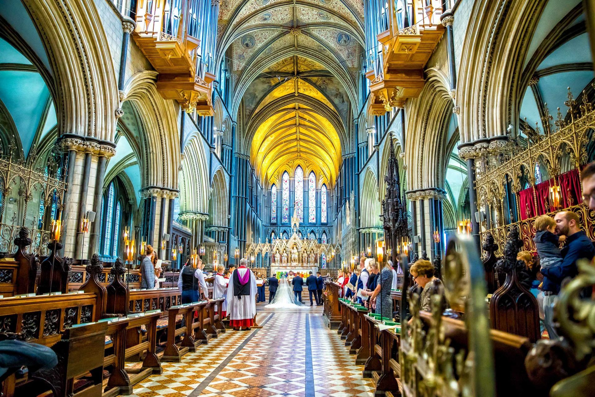A group of people are standing in a church.