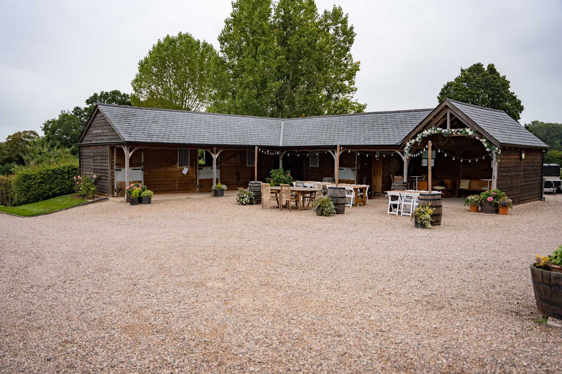 A large building with a gravel driveway in front of it