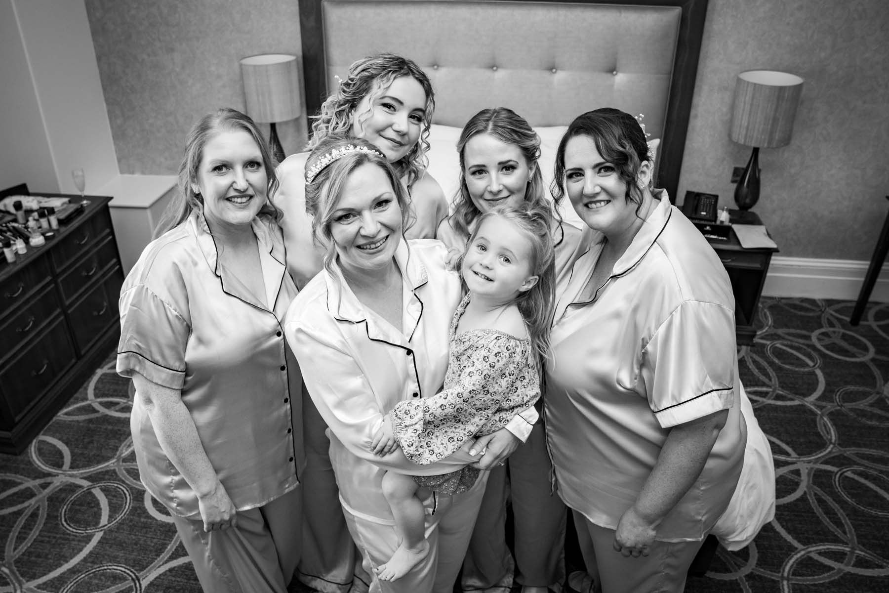 A black and white photo of a bride and her bridesmaids posing for a picture.