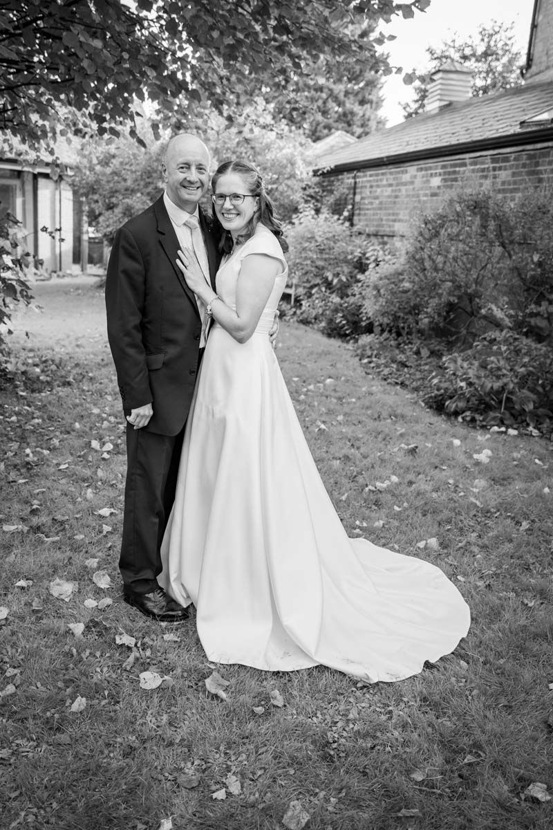 A black and white photo of a bride and groom posing for a picture.