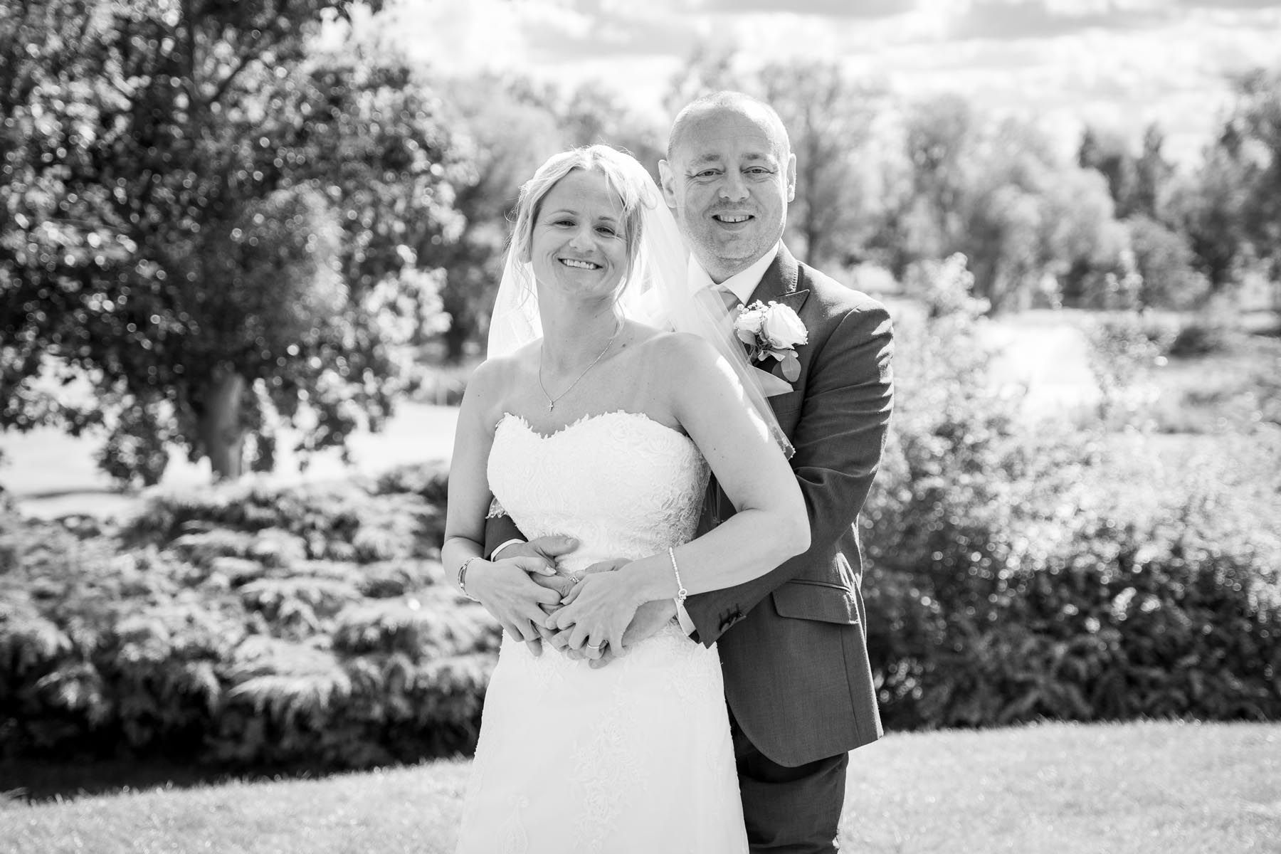 A black and white photo of a bride and groom posing for a picture.