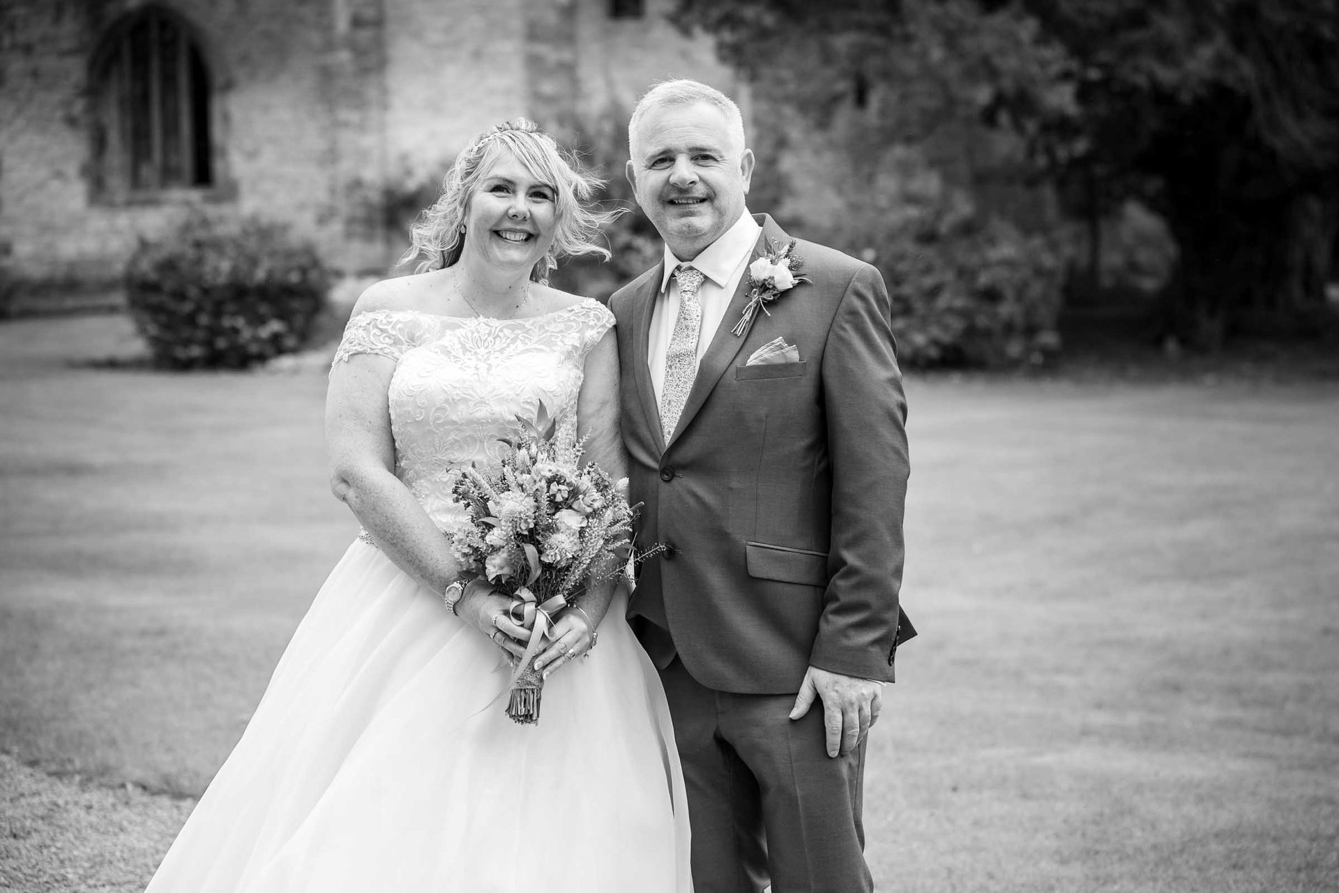 A black and white photo of a bride and groom posing for a picture.