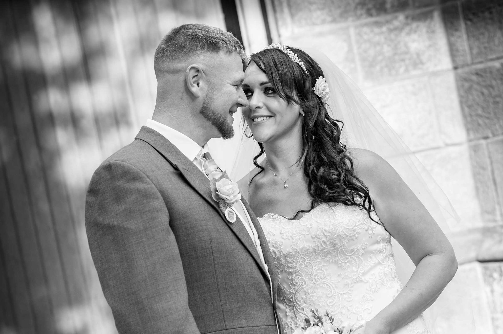 A black and white photo of a bride and groom looking at each other.