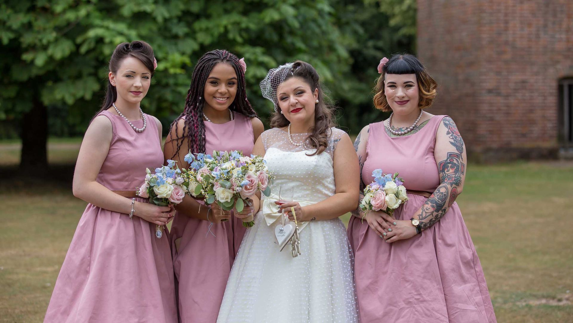 A bride and her bridesmaids are posing for a picture.