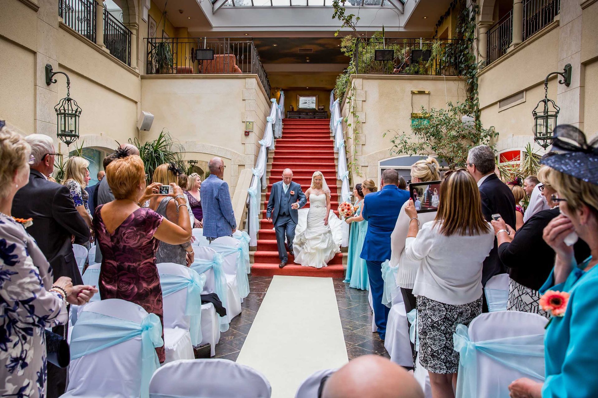 A bride and groom are walking down the aisle at a wedding ceremony.