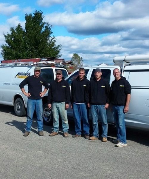 A group of men standing in front of a white van that says paradise