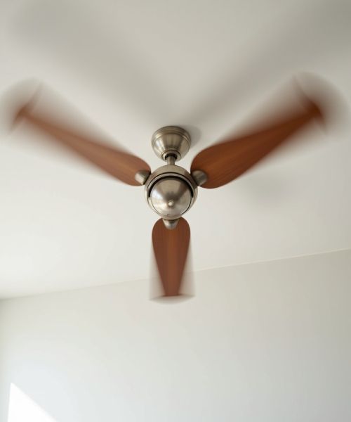 A ceiling fan with wooden blades is spinning in a room