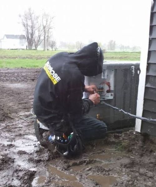 A man wearing a black hoodie with the word moose on it