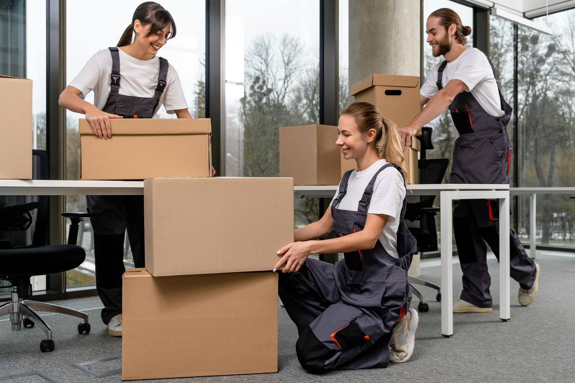 A group of people are moving boxes into an office.