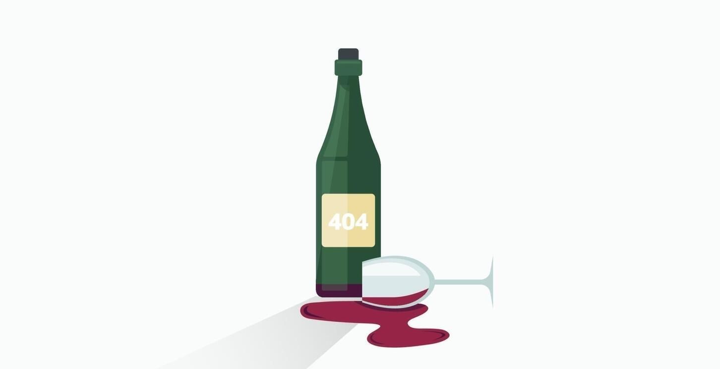 A bottle of wine and a spilled glass of wine.