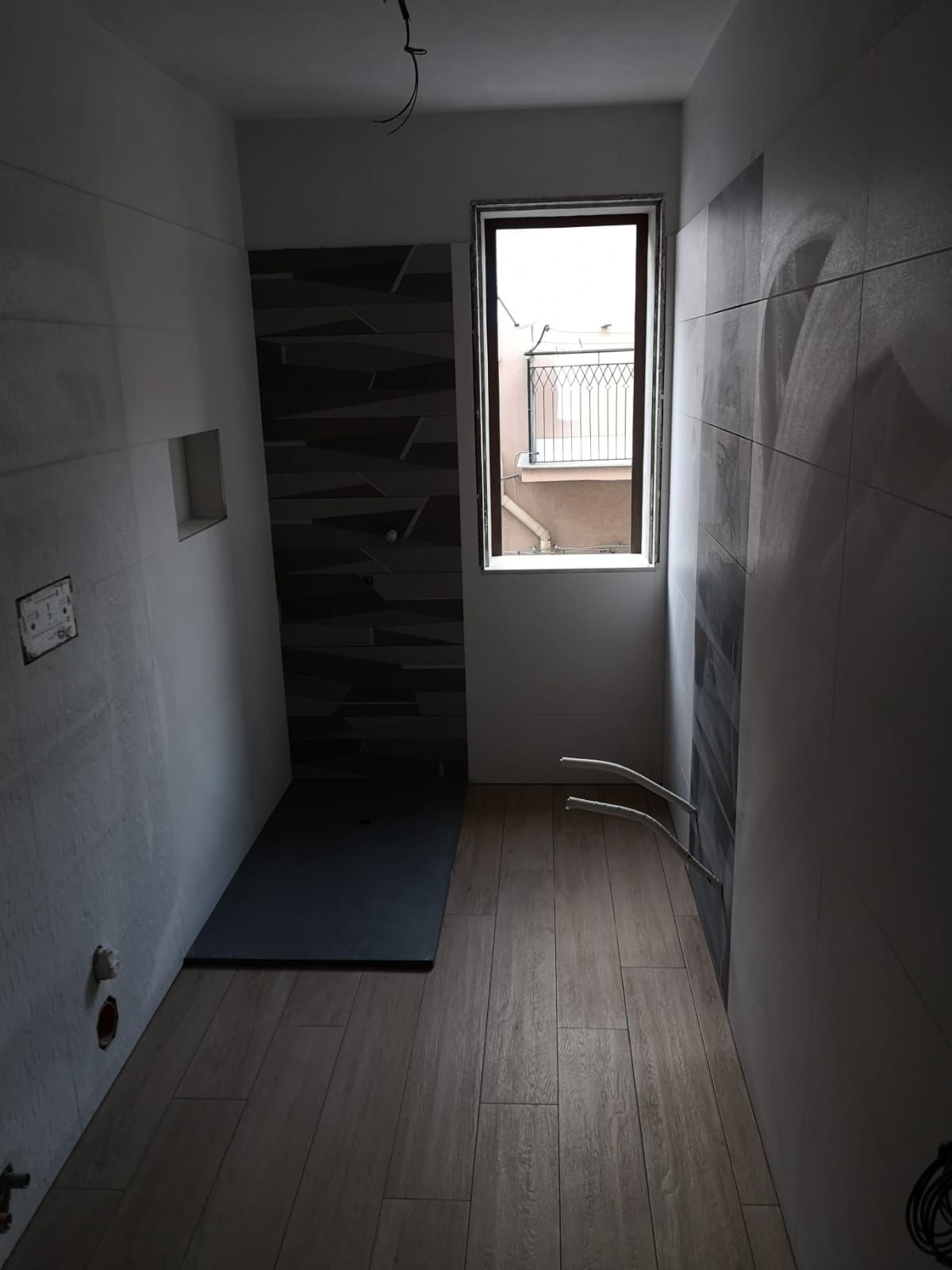 un bagno con piastrelle bianche e nere e una finestra