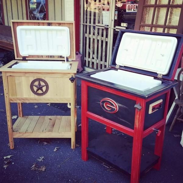 Two red-and-cream wooden coolers with open lids displayed outside a shop