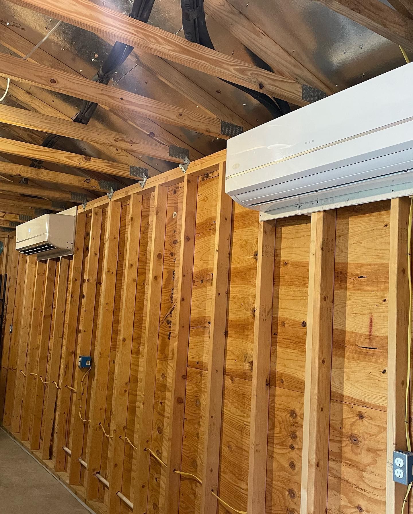A room with a lot of wooden walls and a ceiling.