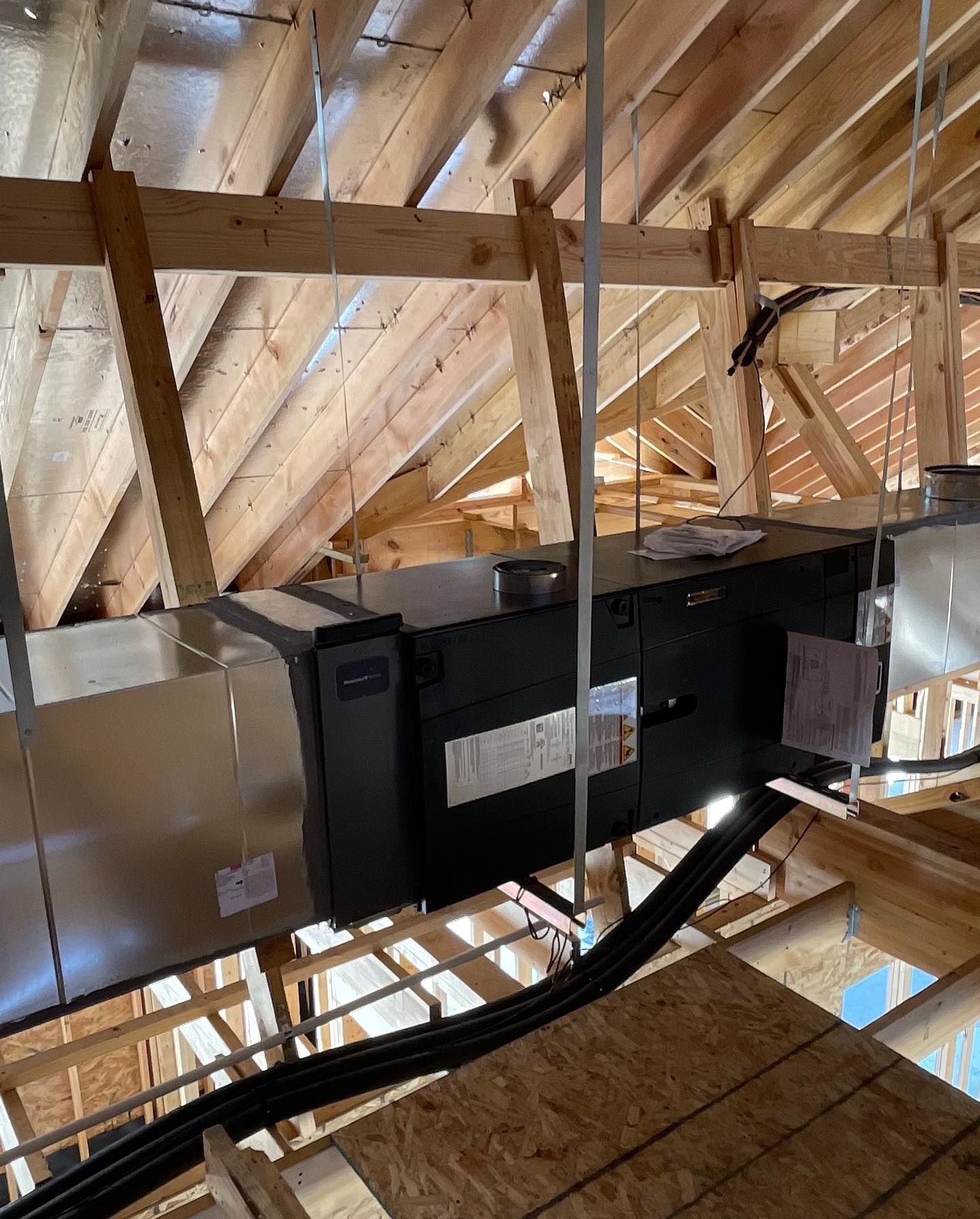 A ceiling with a ventilation system hanging from it.