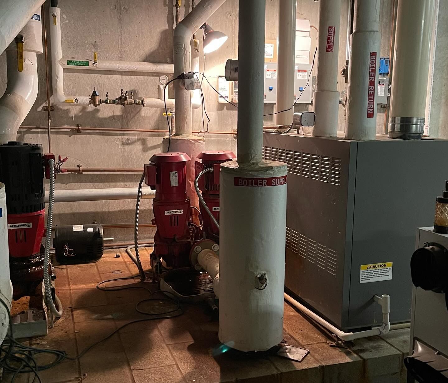 A room with a lot of pipes and a sign that says ' emerson ' on it