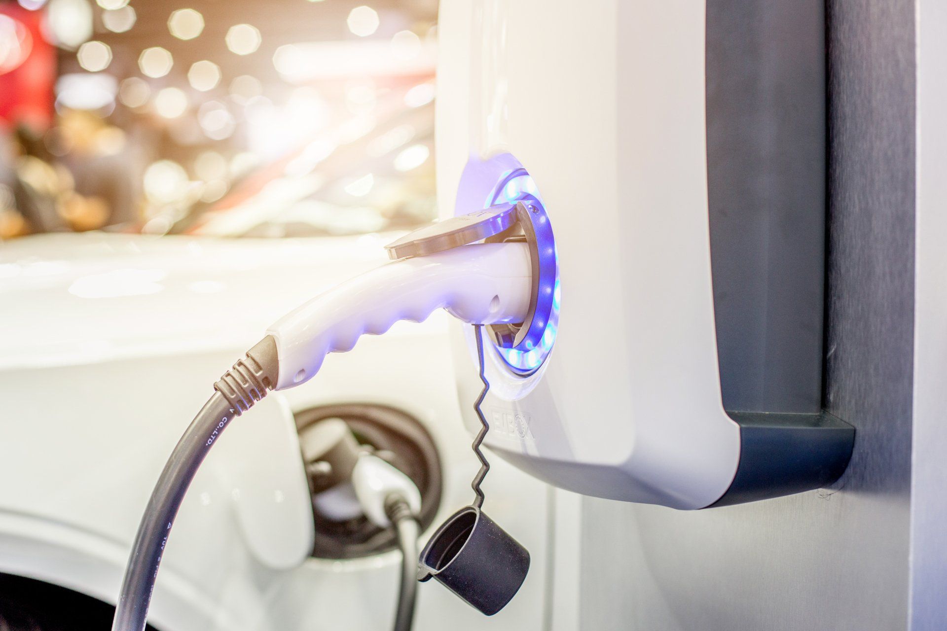 An electric car is being charged at a charging station.