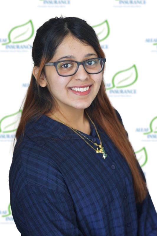 Woman with glasses smiles, wearing a blue shirt, in front of an insurance logo background.