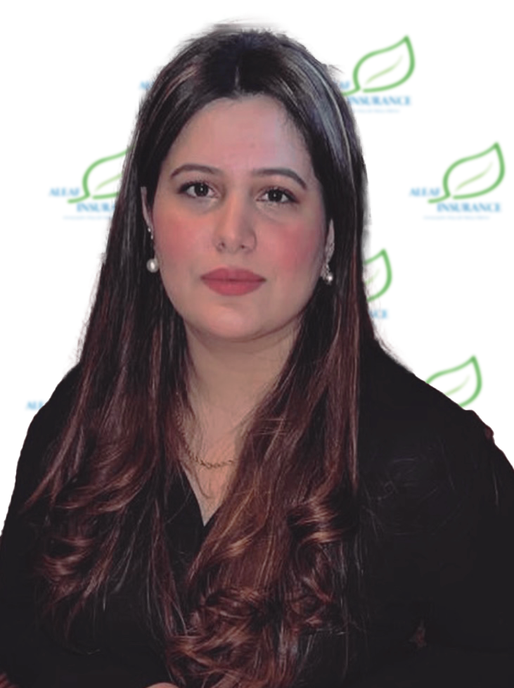 Woman with long brown hair, wearing a dark top, and pearl earrings, with a neutral expression.