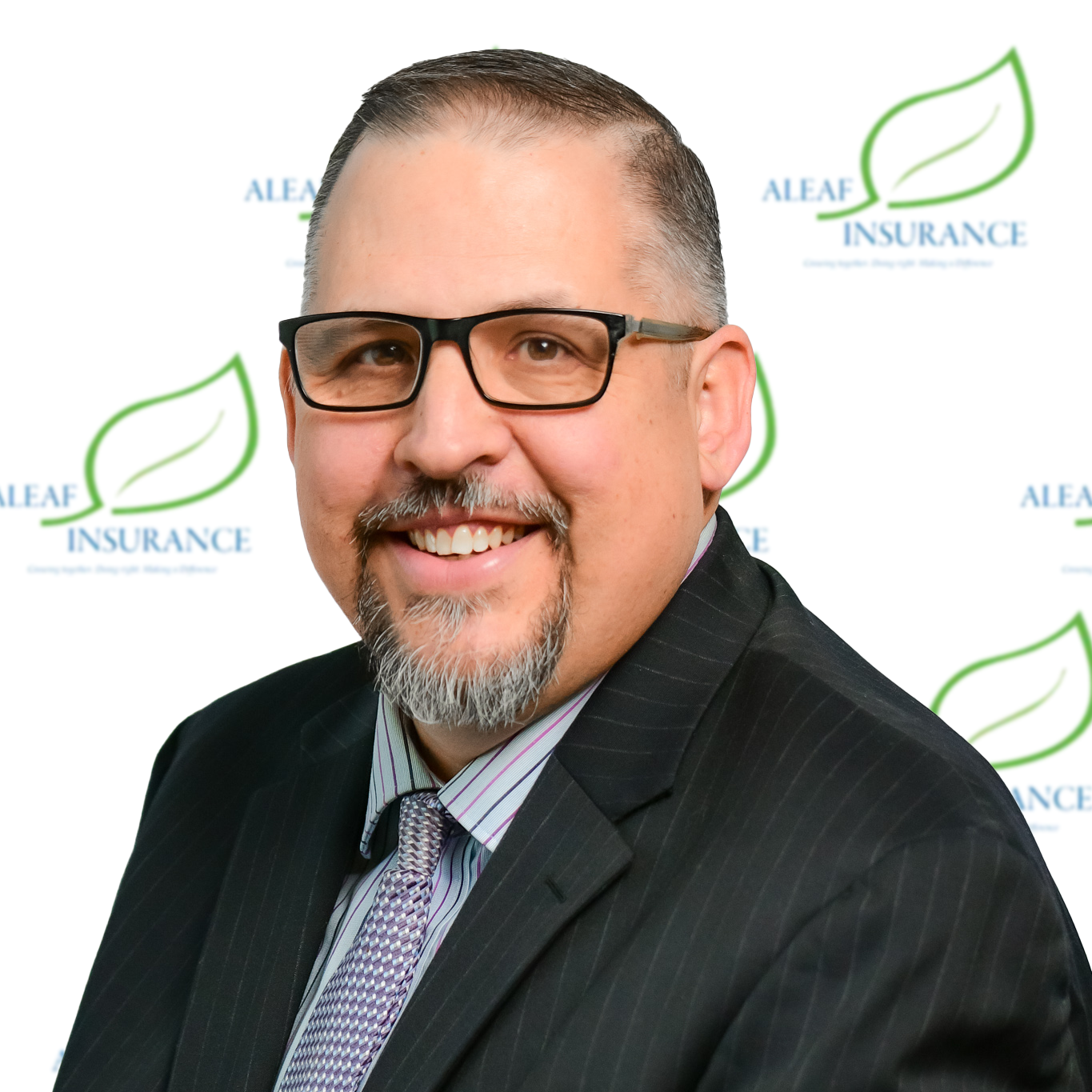 Man in suit and glasses smiling, 