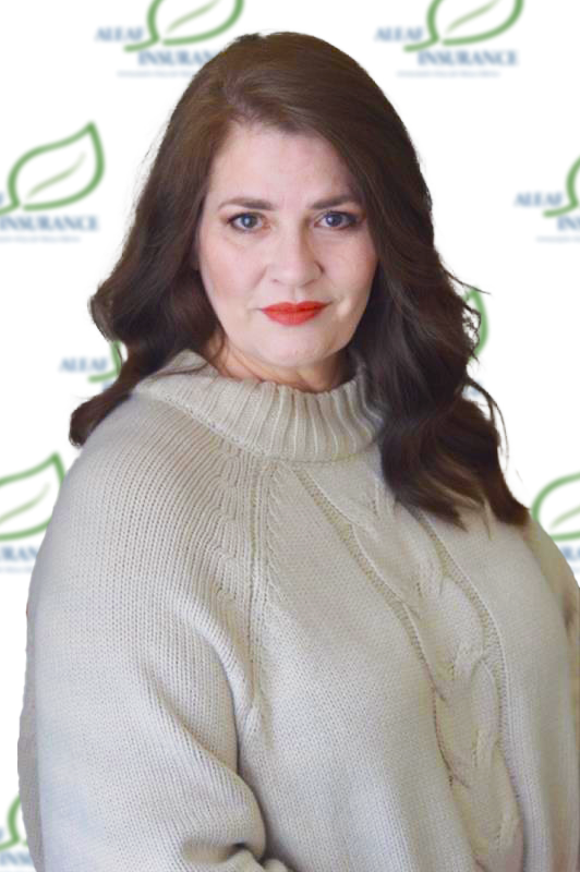 Woman with red lipstick and long brown hair in front of a logo background, wearing a cream cable-knit sweater.