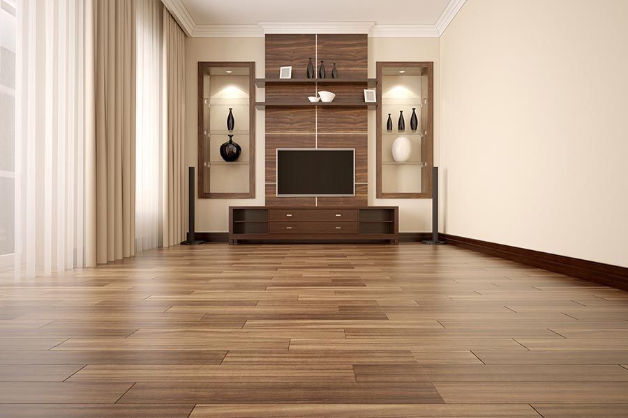 An Empty Living Room With A Wooden Floor And A Flat Screen TV — Crowfoot Constructions NSW, 2830
