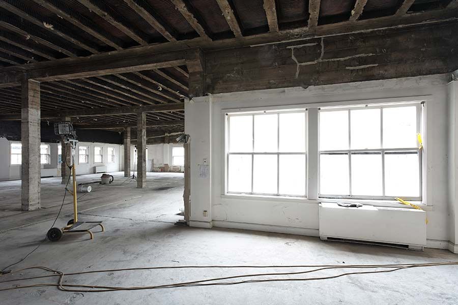 A Large Empty Room With a lot of Windows and Wooden Beams — Crowfoot Constructions NSW, 2830