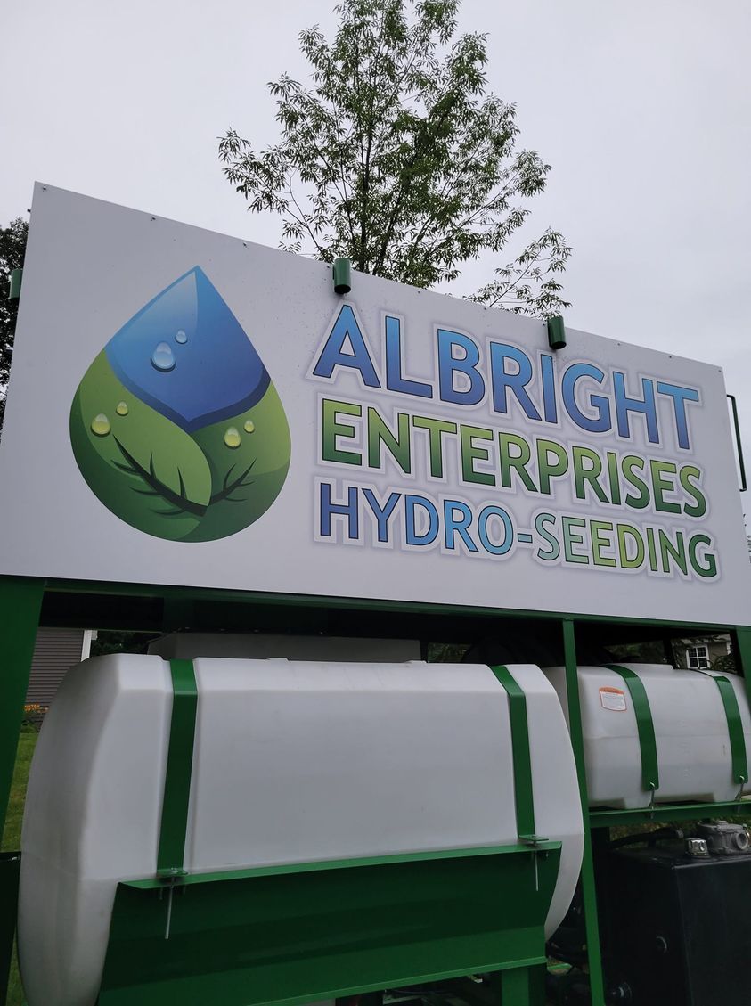 A sign that says albright enterprises hydro-seeding on it