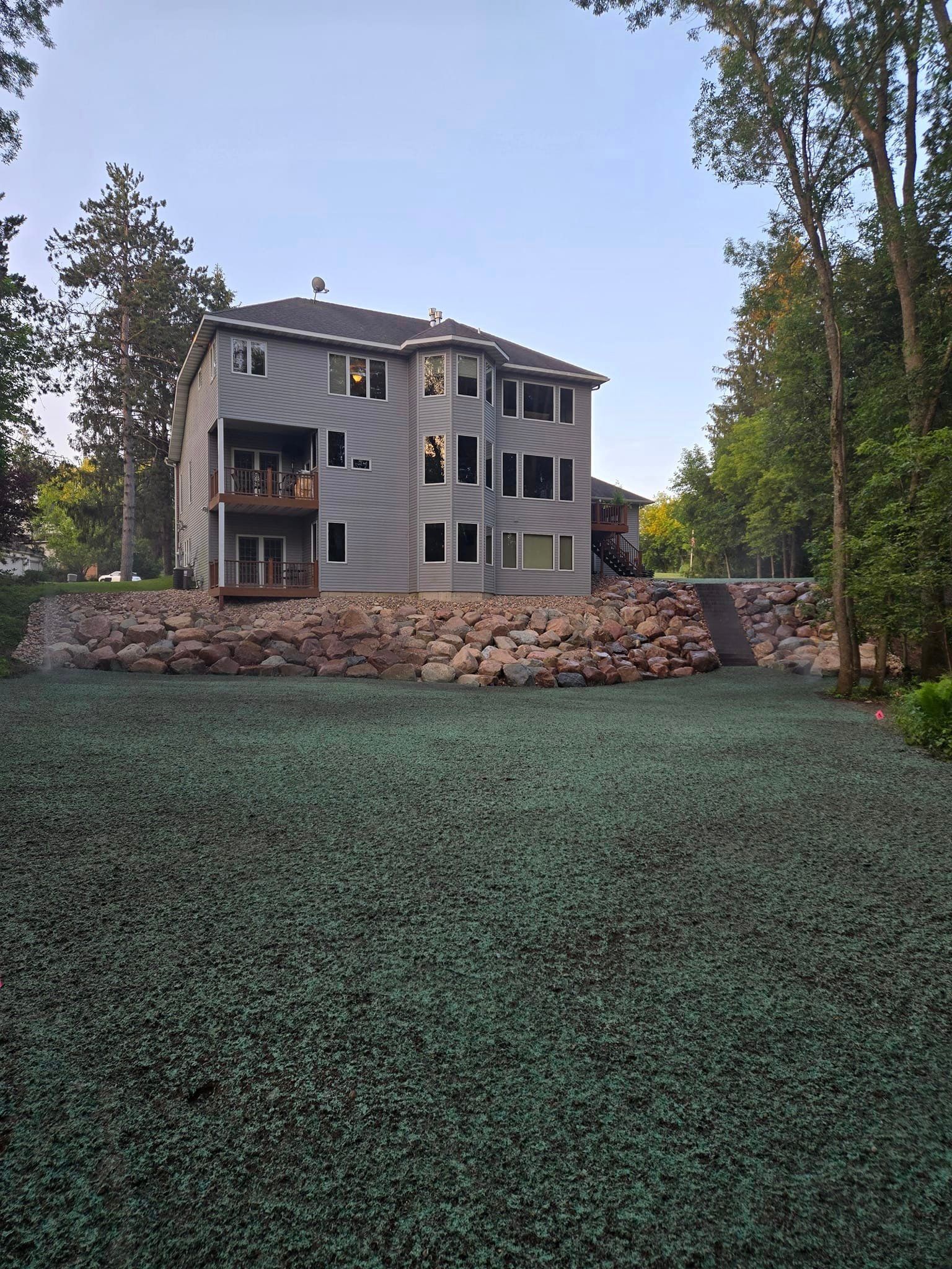 Hydro-seeded yard with large house in background