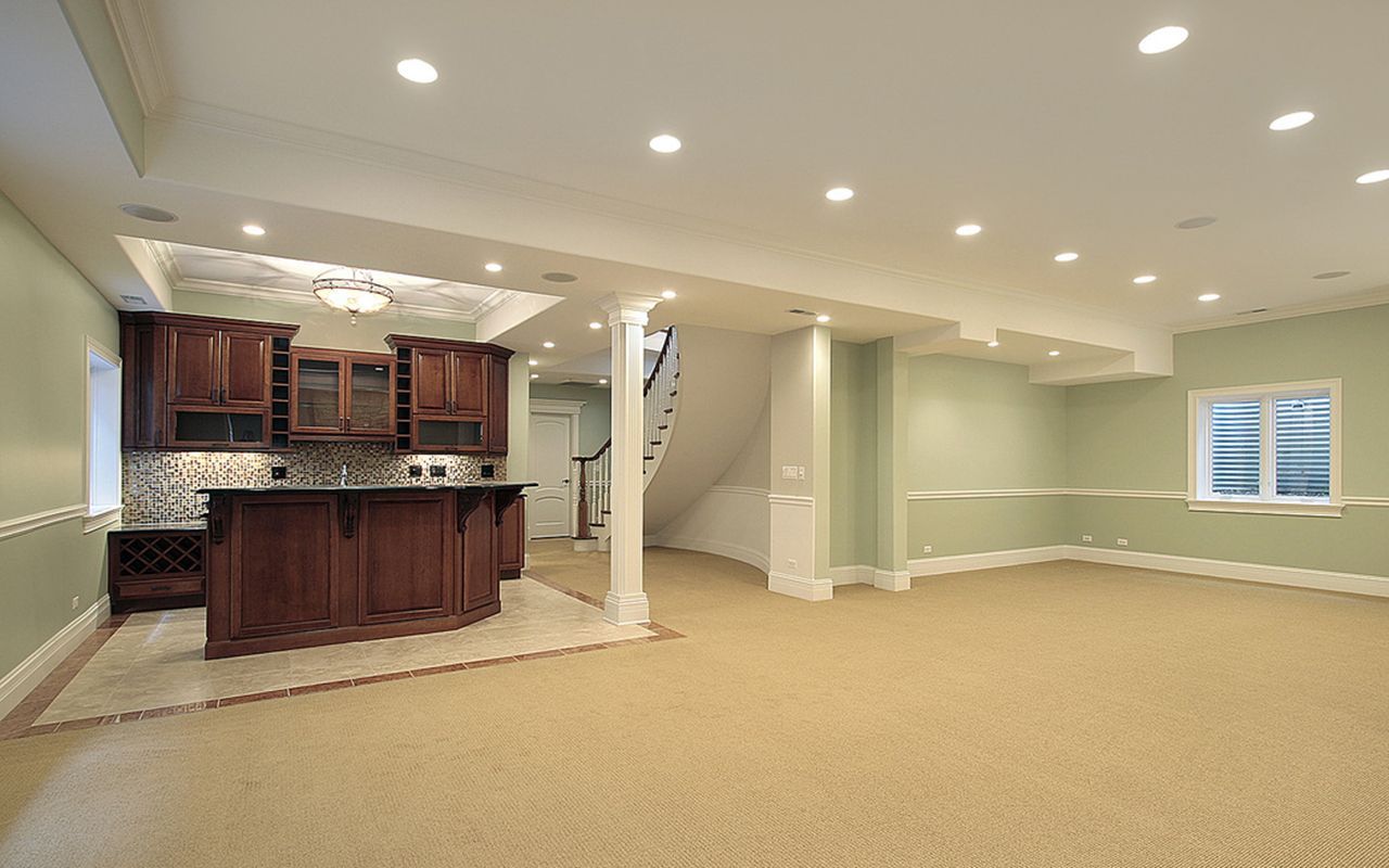 an empty basement with a window in the corner