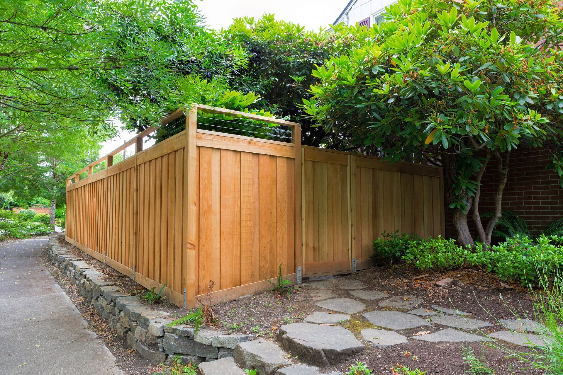 Freshly installed cedar wood fencing bordering the side yard, exuding a natural and rustic charm.