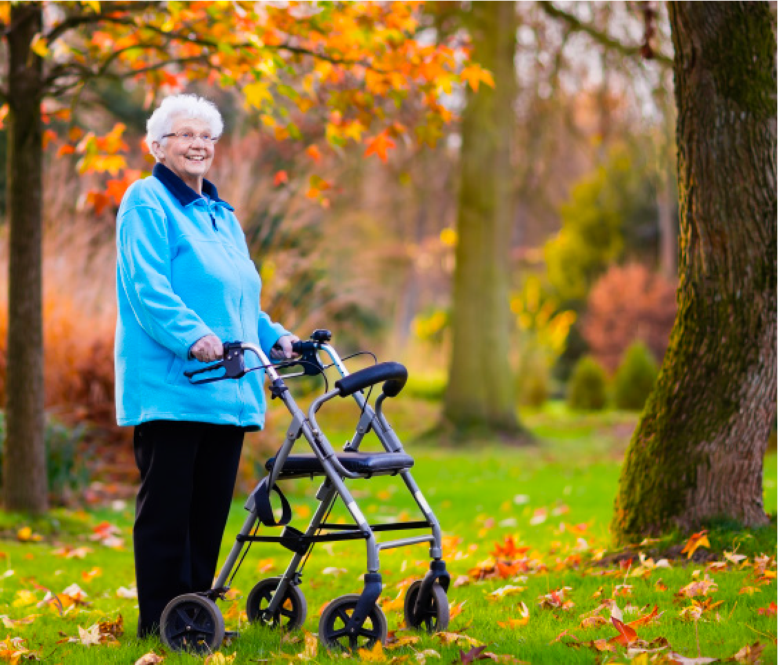 An old lady standing with a walker