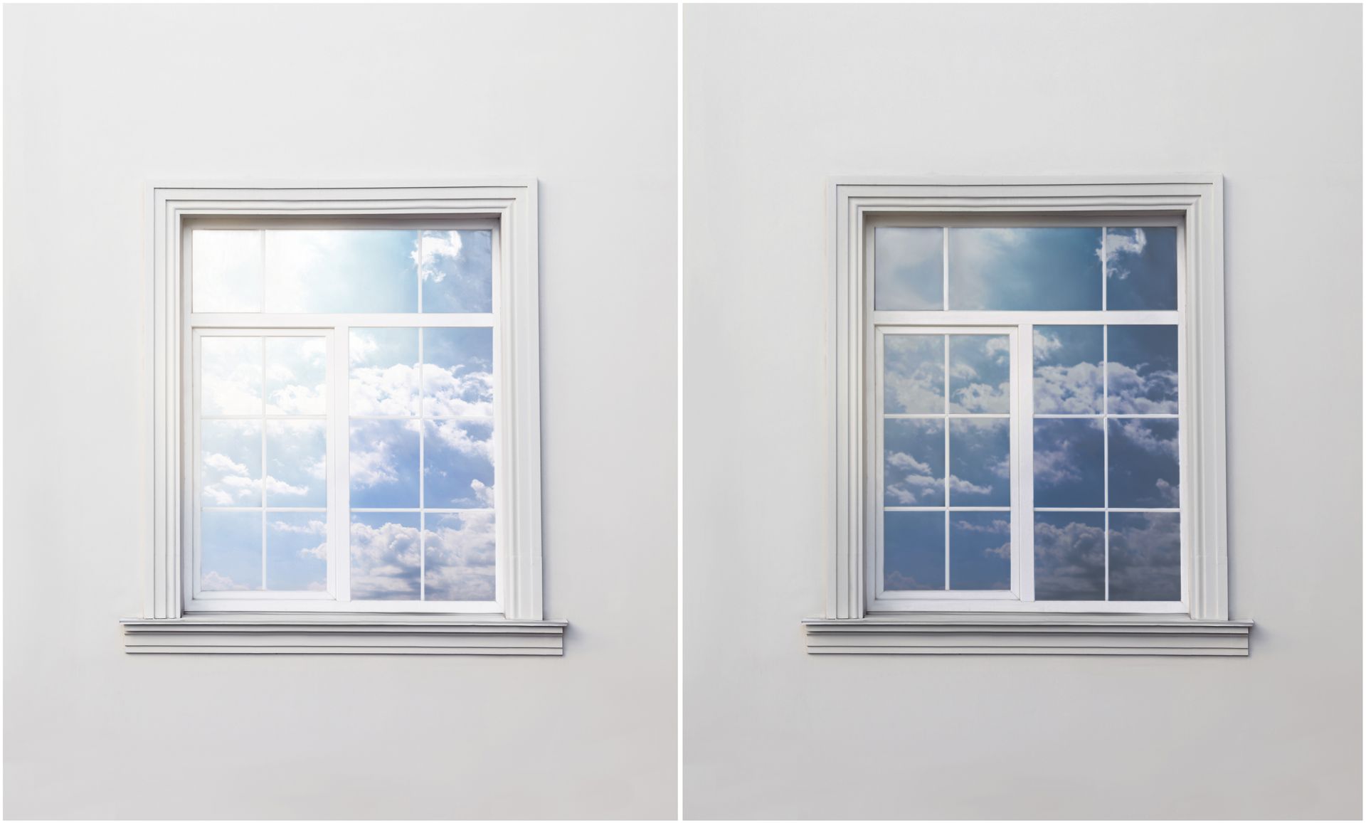 Two windows on a white wall with the sun shining through them.