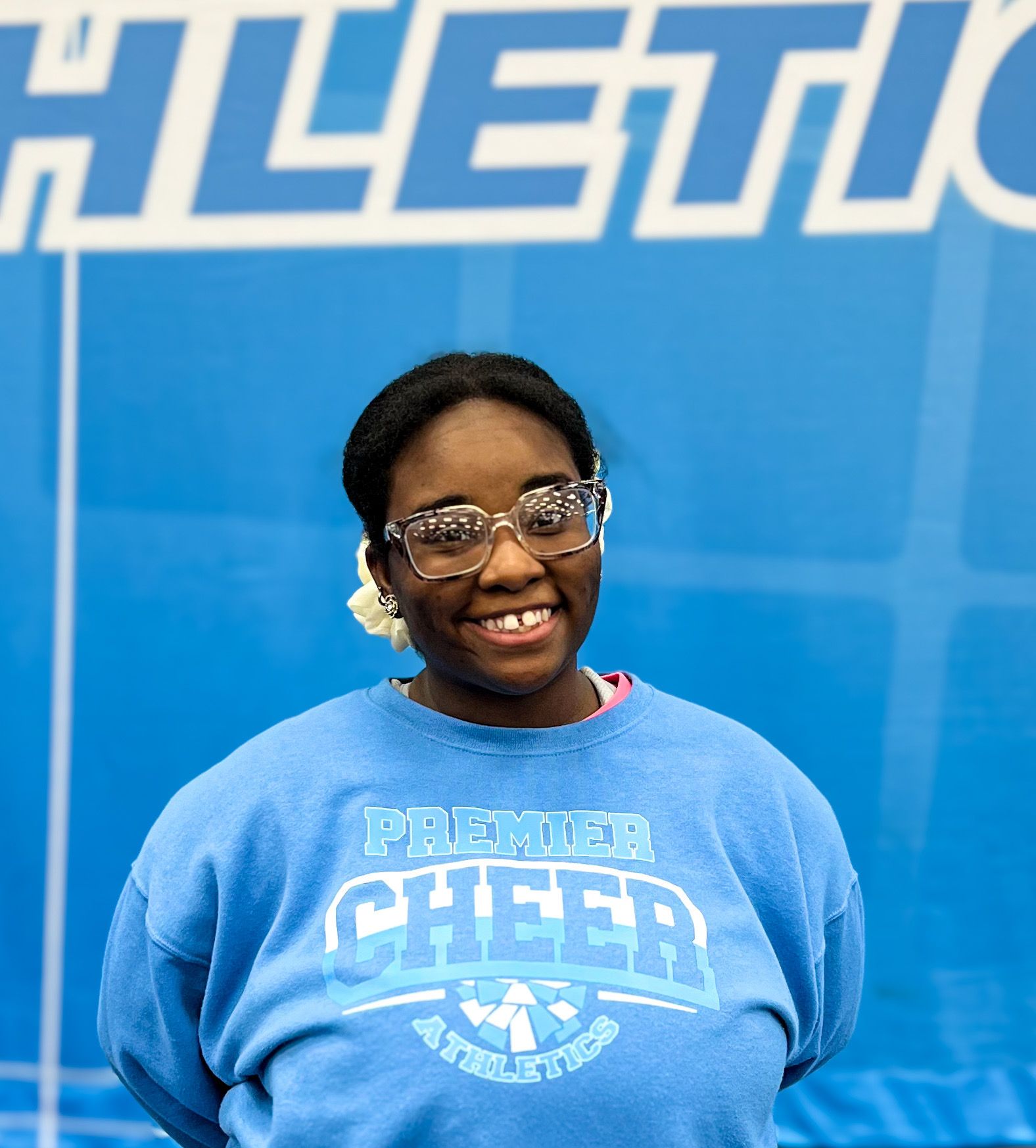 A woman wearing a blue shirt that says cheer