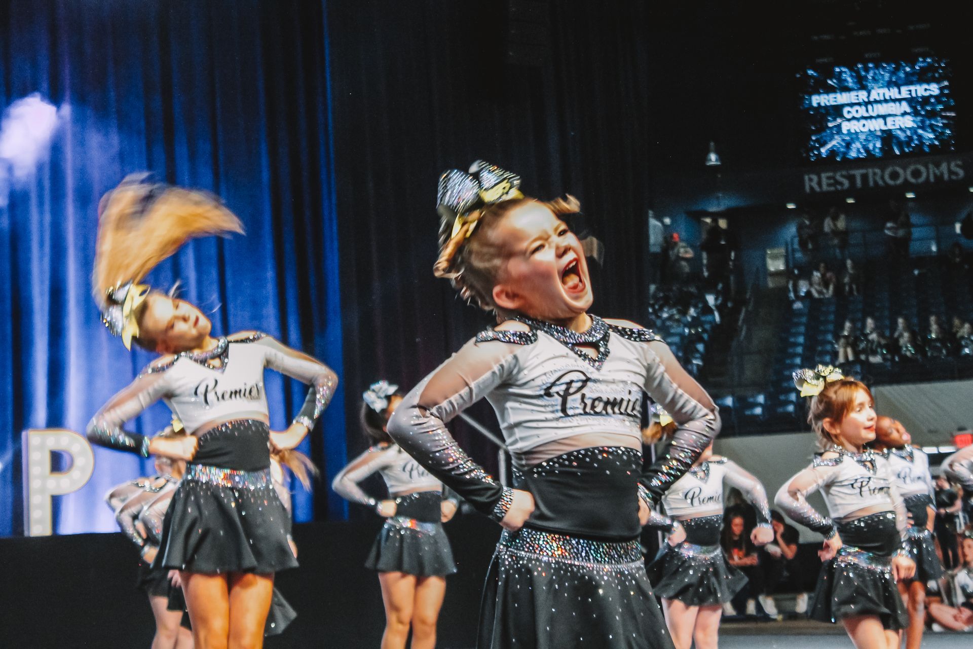 A group of cheerleaders are performing on a stage.