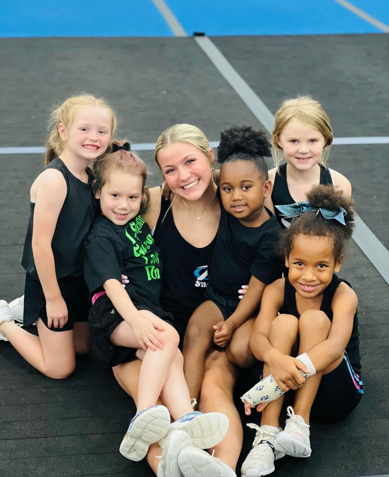 A group of young girls are posing for a picture with their coach